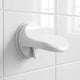 Bathroom suction cup foot rest pedal mounted on a shower wall